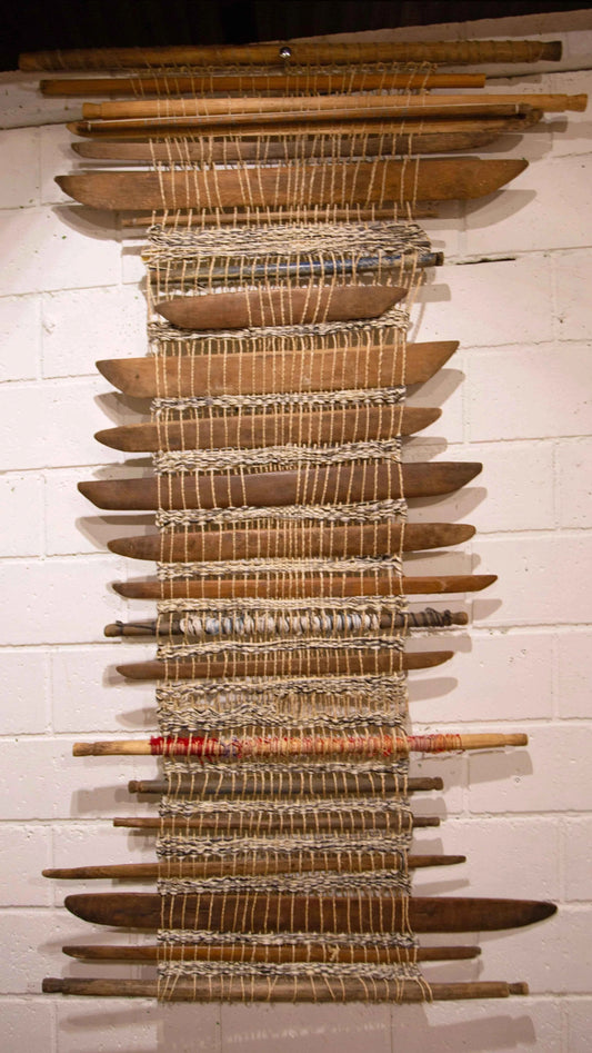 Cool wall art made from old weaving outils.