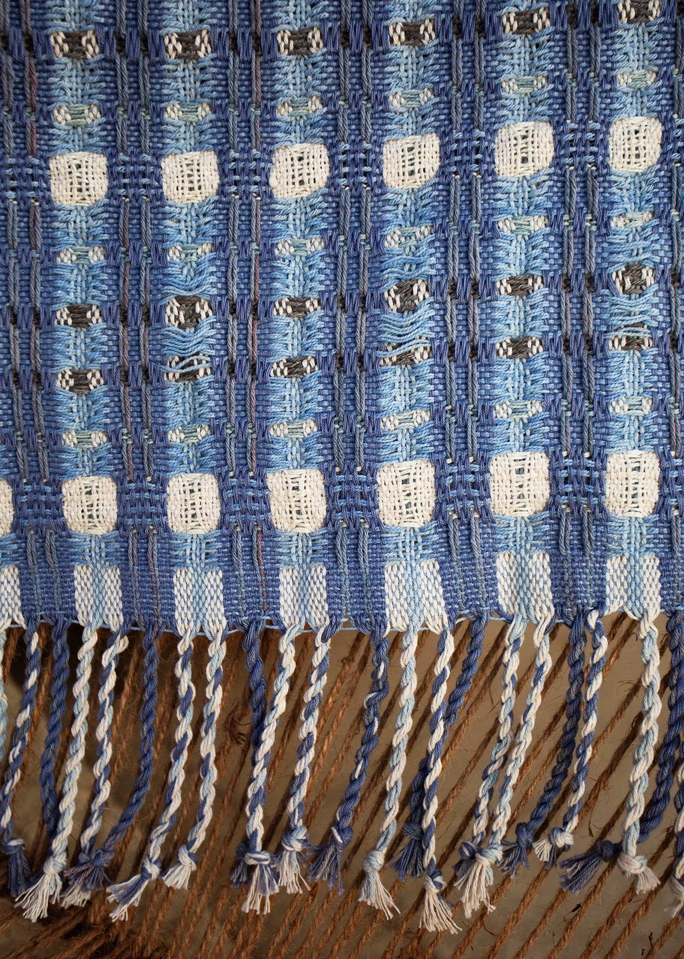 Closeup of a blue doubleweave table runner hand-made on a floor loom with natural dyes at the Maia Organic Studio in Attilan, Guatemala