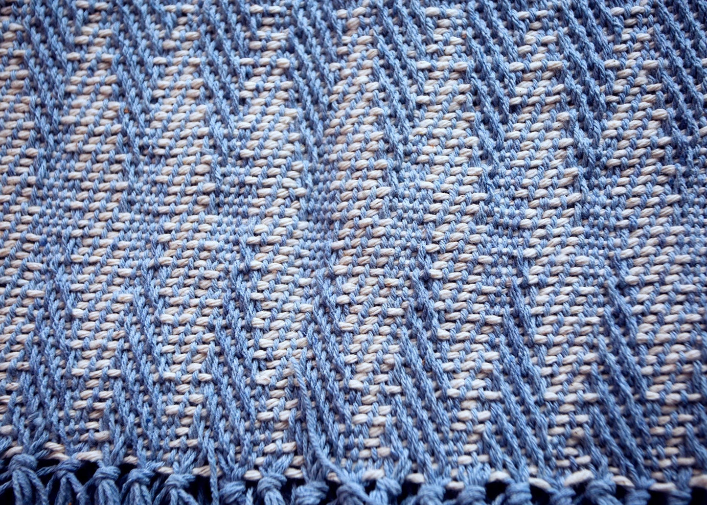 Texture of a blue zig-zag table runner made with natural dyes in the Maia Organic Studio in Atitlan, Guatemala